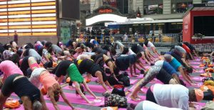 People perform yoga exercises on June 20, 2016 on Times Square in New York City. Yogis from throughout the world travel every year to Times Square to celebrate the Summer Solstice with free yoga classes in the heart of New York City, on what is the Northern Hemispheres longest day of the year.  / AFP / Brigitte DUSSEAU        (Photo credit should read BRIGITTE DUSSEAU/AFP/Getty Images)